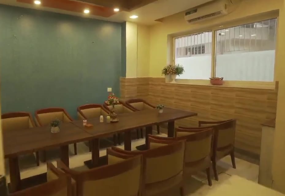 The meeting room: a long table with upholstered chairs, under a window