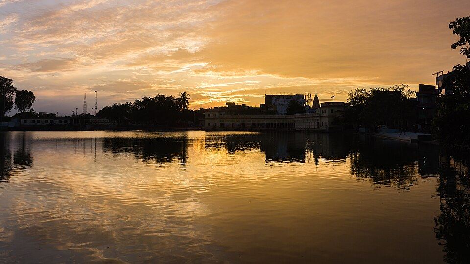 Sunset over the still water of Ganga Sagar